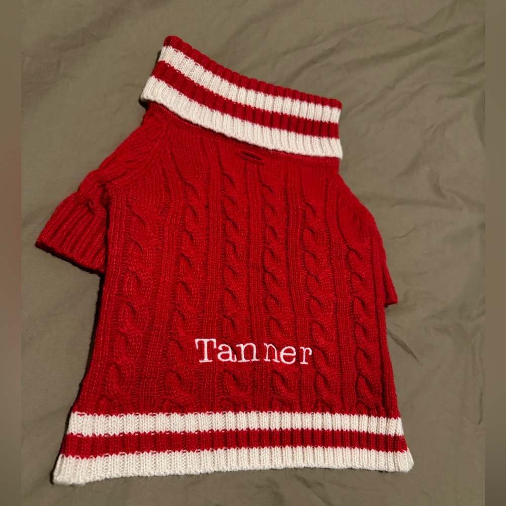 Red and white dog sweater. Customized name “Tanner”